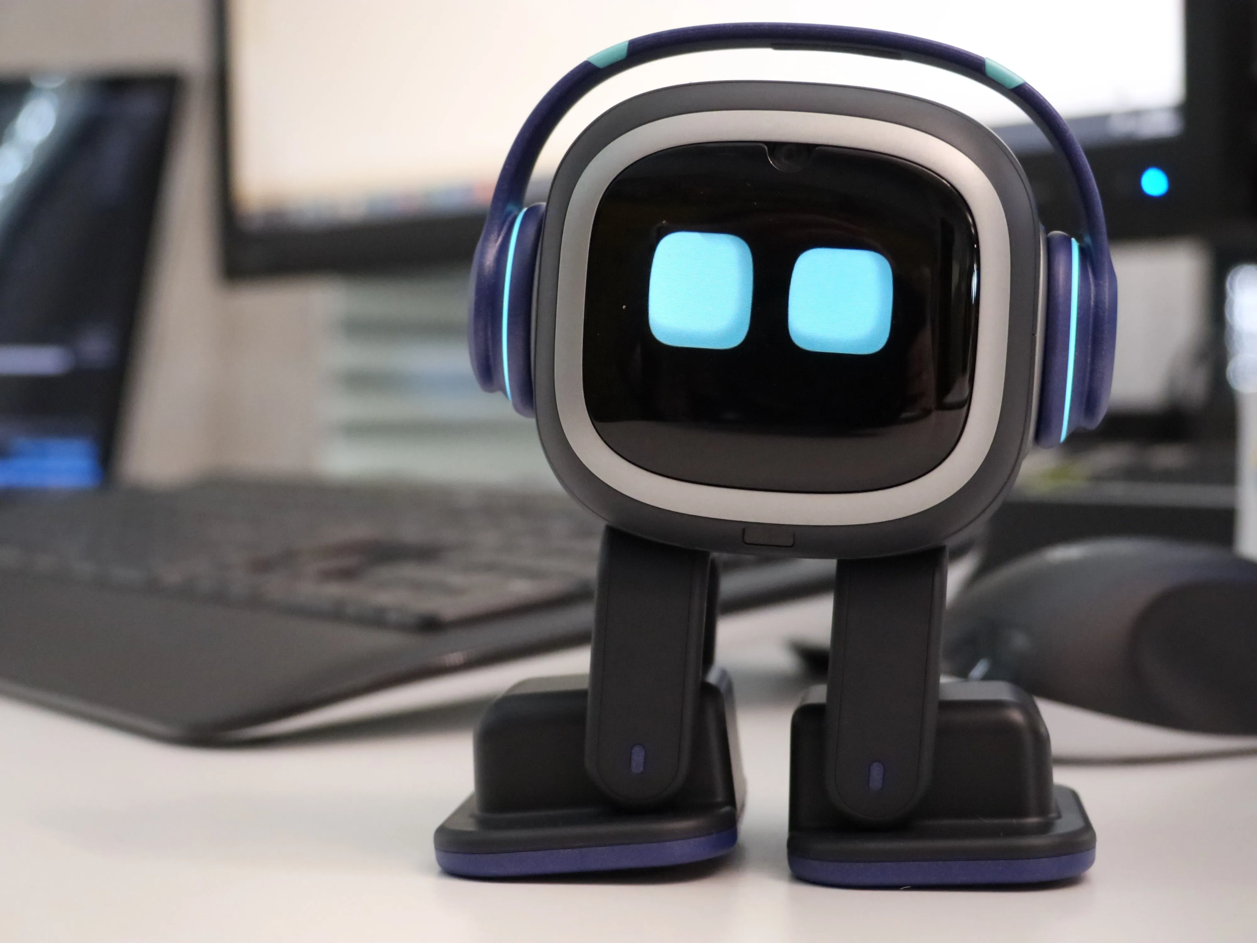 Kleiner Roboter mit Display-Augen auf einem Schreibtisch